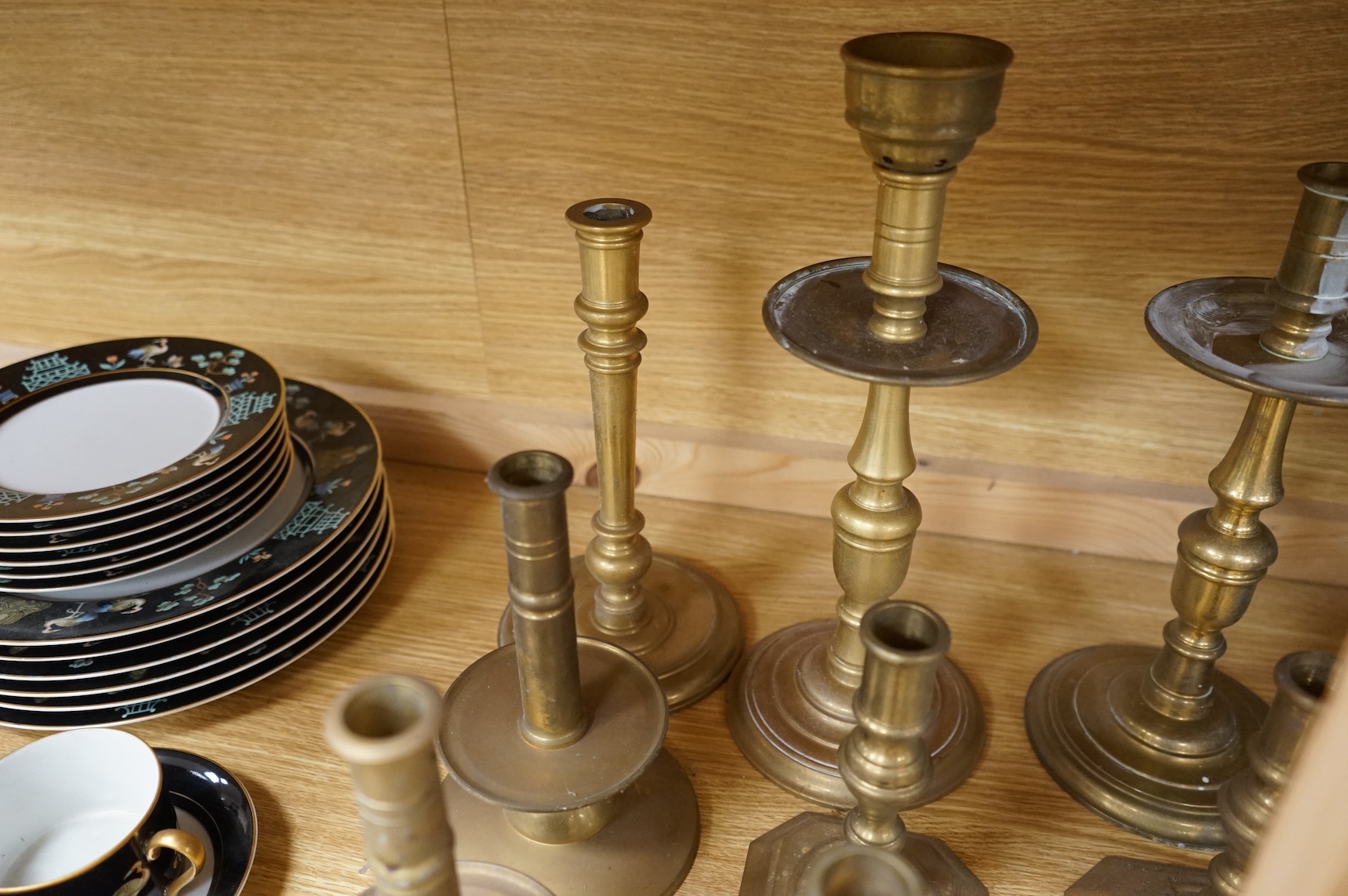 A collection of 19th century and later brass candlesticks, largest 33cm high